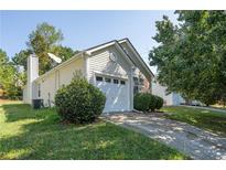 Charming home featuring vinyl siding, an attached garage, and a well-maintained front lawn at 1048 Abercorn Way, Douglasville, GA 30134