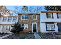 Charming brick townhome featuring a well-manicured front yard and a welcoming entrance at 917 Regency Path Dr, Decatur, GA 30030