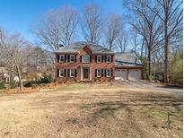 Charming two-story brick home with a well-manicured front yard and a two-car garage at 3270 Sweet Buckeye Dr, Marietta, GA 30066