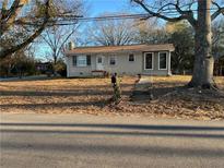 Charming single-story home featuring a stone walkway, manicured front yard, and a classic design with ample natural light at 368 Phillips St, Lawrenceville, GA 30043