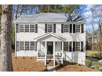 Charming two-story home boasts classic design, black shutters, and a welcoming front porch perfect for relaxation at 3189 Saddleback Mountain Rd, Marietta, GA 30062
