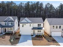 Charming two-story home with white siding, stone accents, and a welcoming front porch at 98 Hampton Ter, Dallas, GA 30157