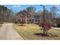 Traditional brick home with manicured lawn and mature trees in a desirable neighborhood at 1760 Carissa Dr, Conyers, GA 30094