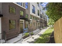 Charming brick townhomes with well-maintained landscaping and inviting entranceways at 201 New St # 2301, Decatur, GA 30030