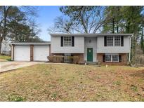 Charming split-level home with a two-car garage and a well-maintained front yard at 3063 Kerr Dr, Decatur, GA 30034