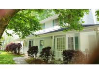 Charming two-story home with a welcoming front porch and lush, mature landscaping at 3875 Wintergreen Ct, Marietta, GA 30062