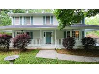 Charming two-story home with a welcoming front porch and a beautifully landscaped front yard at 3875 Wintergreen Ct, Marietta, GA 30062