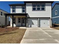 New two-story home features a two-car garage, white siding, a covered porch, and a well-manicured lawn at 2108 Boxwood Circle Se, Conyers, GA 30094