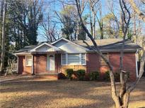 Charming single-story brick home with a well-maintained front yard and mature trees at 2736 Claire Ter, Decatur, GA 30032