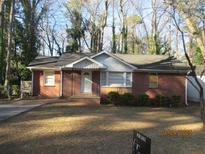 Charming brick house with a well-maintained lawn and a 'For Sale' sign at 2736 Claire Ter, Decatur, GA 30032