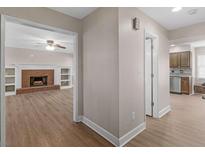 Inviting living room features a cozy brick fireplace flanked by custom built-in shelving at 105 Lakeview Ln, Stockbridge, GA 30281