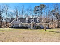 Charming single-story home with dormer windows and a well-maintained lawn at 487 Glendale Ct, Stone Mountain, GA 30087