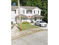 Charming two-story townhome with a well-maintained front lawn and driveway at 1210 Pinedale Nw Cir, Conyers, GA 30012