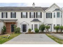 Charming townhome with black shutters, manicured landscaping and a driveway for easy parking at 32 Hampton Dr, Cartersville, GA 30121
