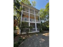 Charming multi-story home with stacked porches, brick facade, and a lovely landscaped yard at 397 4Th Ne St, Atlanta, GA 30308