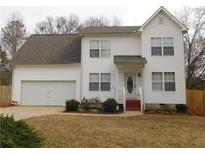 Charming two-story home with white siding, attached garage, and well-maintained front yard at 554 Samaritan Dr, Cumming, GA 30040