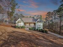 Charming, single-story home with manicured landscaping, inviting curb appeal and a covered porch at 320 Red Fox Dr, Canton, GA 30114
