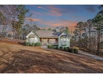 Charming single-Gathering home with a manicured lawn, covered porch, and long driveway at 320 Red Fox Dr, Canton, GA 30114