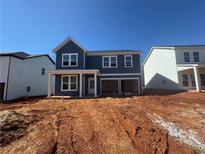 Two-story home with navy siding, white trim, and an attached two-car garage at , Conyers, GA 30094