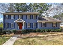 Charming two-story home with a well-manicured front lawn and a classic blue exterior at 4650 Sharon Valley Ct, Atlanta, GA 30360