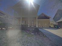 Inviting two-story home with a charming front porch, attached two-car garage, and a well-manicured lawn at 5532 Union Pointe Pl, Union City, GA 30291