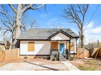 Charming one-story home with a blue front door, gray roof, and wooden porch at 1114 Oak Knoll Se Ter, Atlanta, GA 30315