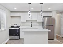 Bright, modern kitchen with stainless steel appliances and a center island at 2106 Singer Way, Lithonia, GA 30058