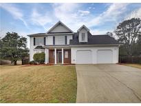 Charming two-story home with a well-maintained lawn and a two-car garage at 3745 Talbot Nw Ln, Acworth, GA 30101