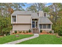 Charming two-story home featuring a stone foundation, welcoming front porch and beautifully landscaped front yard at 1720 Little Willeo Rd, Marietta, GA 30068