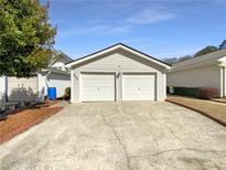 Two car attached garage with a large driveway for extra parking at 949 Bobcat Se Ct, Marietta, GA 30067