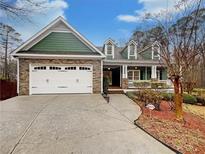 Charming two-story home featuring a two-car garage and a welcoming front porch at 115 Sable Ridge Dr, Acworth, GA 30102