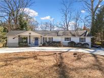 Charming single-story home featuring a welcoming front porch, blue door and a well-manicured lawn at 194 Church Se Rd, Smyrna, GA 30082