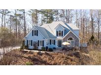 Charming two-story home with blue siding, stone accents, and a well-manicured front yard at 210 Wrights Mill Way, Canton, GA 30115