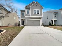 Charming gray two-story home with a two-car garage and a well-maintained front yard at 163 Denver Ave, Hiram, GA 30141