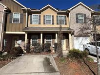 Charming townhome featuring a welcoming entryway, a private garage, and beautiful landscaping at 1970 Old Dogwood, Jonesboro, GA 30238