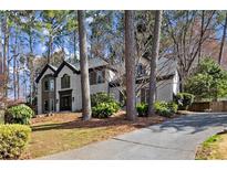 Traditional two-story home with a white brick exterior, dark trim, and mature landscaping at 203 Northside Nw Dr, Kennesaw, GA 30144