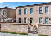 Charming brick townhouse with gated entry, showcasing architectural details and curb appeal at 3475 Landen Pine Ne Ct, Atlanta, GA 30305