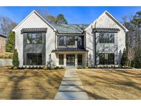 Stunning two-story home with a stone walkway, a manicured lawn, and a modern facade at 372 Karen Dr, Alpharetta, GA 30009