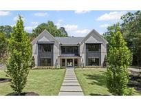 Stunning two-story home with black trim windows, beautifully landscaped yard, and inviting walkway at 372 Karen Dr, Alpharetta, GA 30009