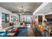 Bright and airy living room with a large sectional sofa and modern decor with a spacious kitchen in the background at 845 Spring Nw St # 502, Atlanta, GA 30308