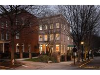 Charming brick home with manicured landscaping and inviting front porch, radiating warmth and curb appeal in an urban setting at 895 Inman Village Ne Pkwy, Atlanta, GA 30307