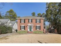 Charming two-story red brick home with black shutters and a manicured front lawn at 1030 Eulalia Ne Rd, Atlanta, GA 30319