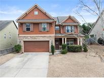 Charming two-story home with a two-car garage, well-maintained lawn, and craftsman features at 3940 Village Estates Ct, Cumming, GA 30040
