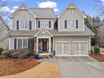 Charming two-story home with gray siding, black shutters, and a well-manicured front yard at 2061 Westwood Cir, Smyrna, GA 30080