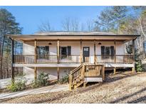 Charming home featuring a large front porch with wooden beams and railings at 210 Joe Green Ln, Canton, GA 30114