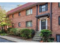 Charming brick townhouse with a red tile roof and well-manicured landscaping at 327 3Rd Ne St # 1, Atlanta, GA 30308