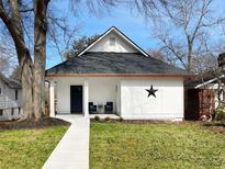 Charming bungalow with a crisp white exterior, black star detail, and a welcoming walkway at 1416 Mcpherson Se Ave, Atlanta, GA 30316