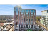 Modern high-rise building with brick facade and numerous windows providing stunning city views at 1820 Peachtree Nw St # 1207, Atlanta, GA 30309