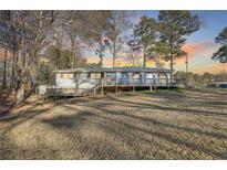 Ranch-style home featuring a cozy front porch and expansive lawn at 17 Cross Creek Pkwy, Dallas, GA 30157