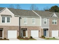 Charming townhomes featuring brick accents and individual garages for modern living at 510 Campeche Dr, Locust Grove, GA 30248